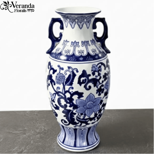 Tall blue and white ceramic vase with handles and floral pattern