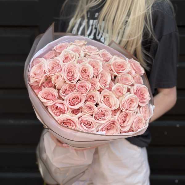 Large bouquet of pale pink roses wrapped in blush paper