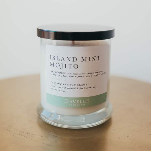 Glass candle jar with a black lid and Island Mint Mojito label