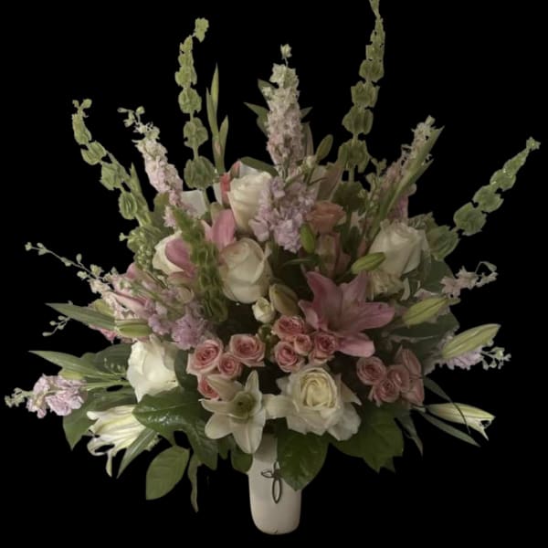 Pink and white floral arrangement in a white vase