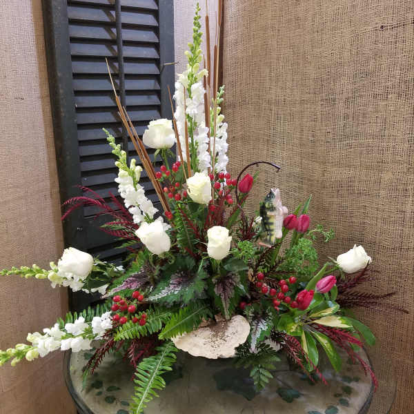 Tall floral arrangement with white roses, white snapdragons, and pink tulips