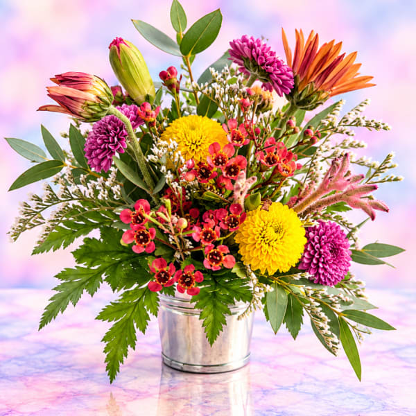 Colorful mixed bouquet in a metal bucket vase