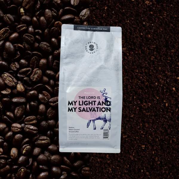 Bag of ground coffee on a background of coffee beans and grounds