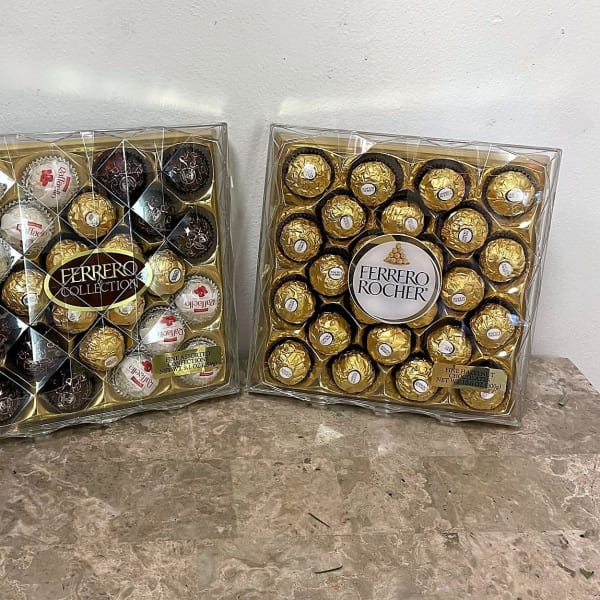 Two boxed Ferrero Rocher chocolate assortments on a tabletop