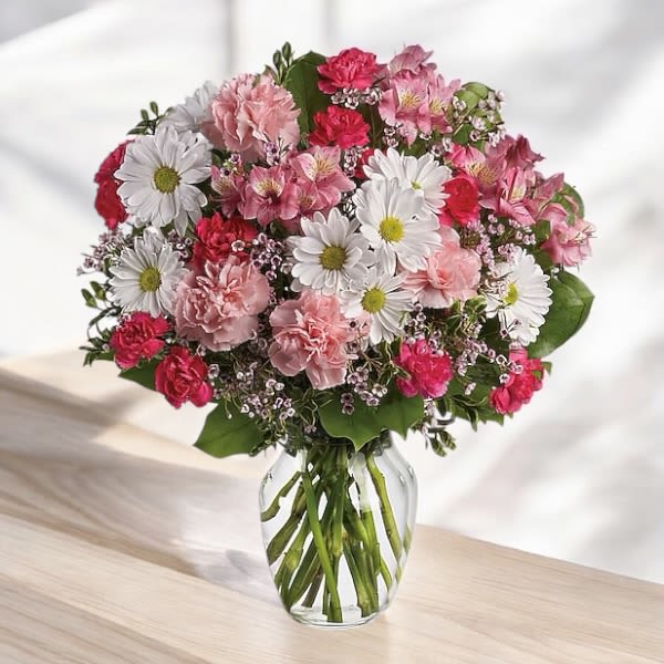Pink and white mixed bouquet in a clear glass vase