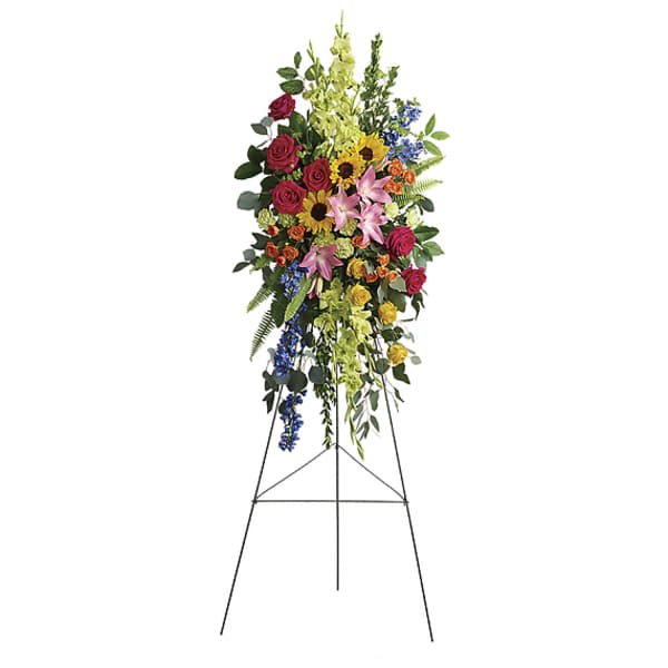 Tall standing floral spray with roses, lilies, sunflowers, and mixed blooms