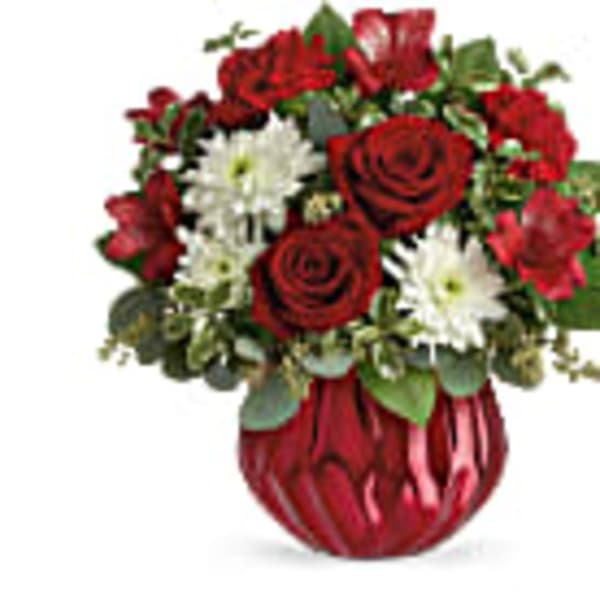 Red roses and white daisies in a red vase