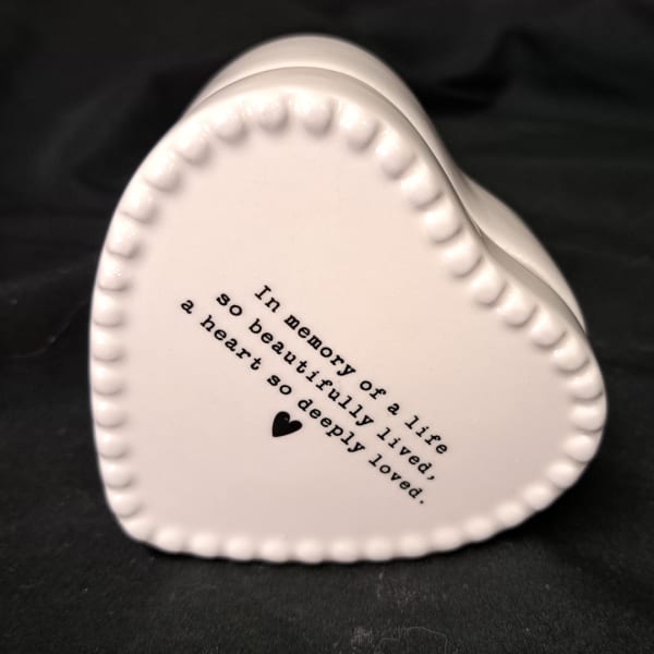 White heart-shaped ceramic keepsake with printed memorial text