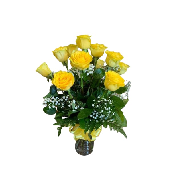 Yellow roses arranged in a glass vase with baby's breath