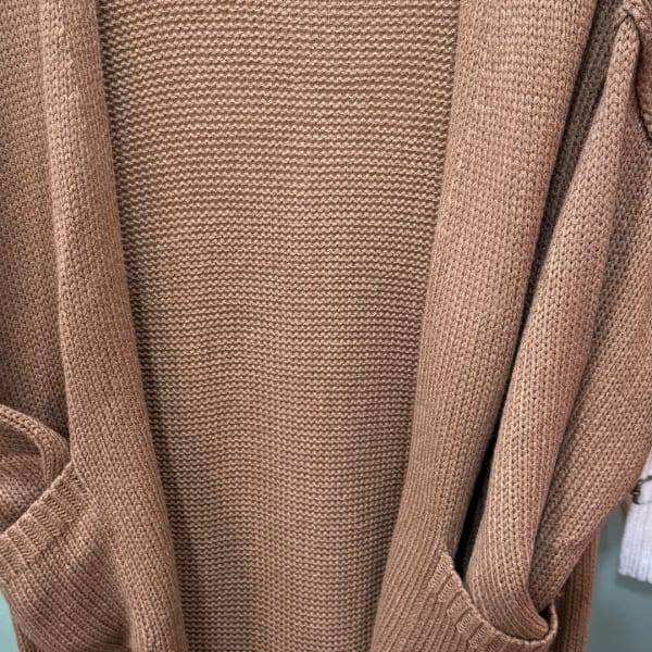 Close-up of a tan knitted cardigan or sweater