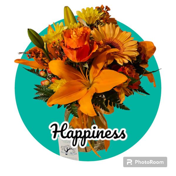Orange and yellow bouquet with lilies and daisies in a vase