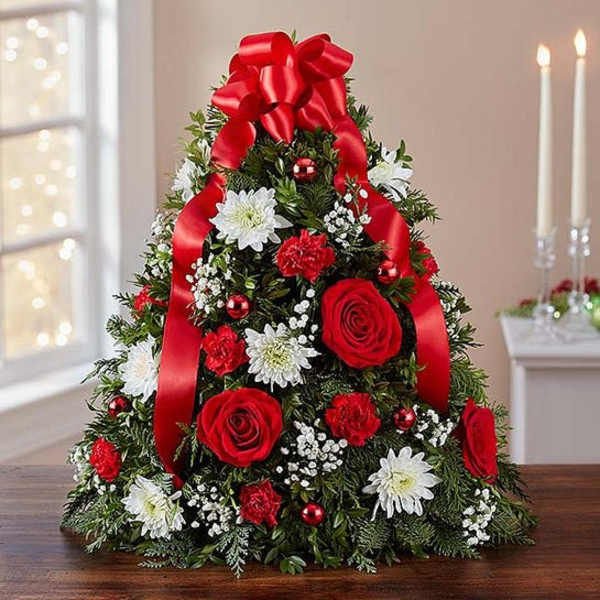 Christmas tree-shaped floral arrangement with red roses and white daisies
