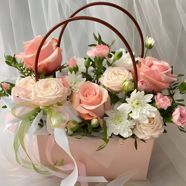 Pink and white roses with daisies in a pink gift basket