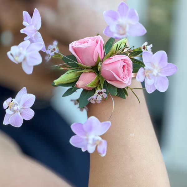 Pink rose wrist corsage with lavender orchid blooms