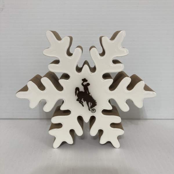 White snowflake-shaped decorative sign with a cowboy logo