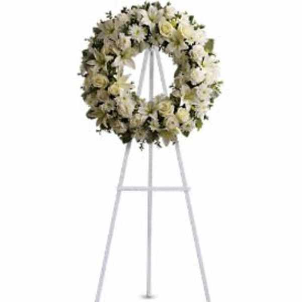 White floral wreath on a standing easel