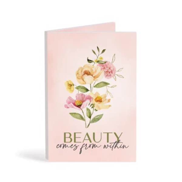 Pink greeting card with watercolor flowers and the words "beauty comes from within"