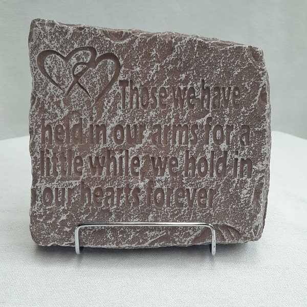 Engraved stone plaque with a heart design and memorial quote
