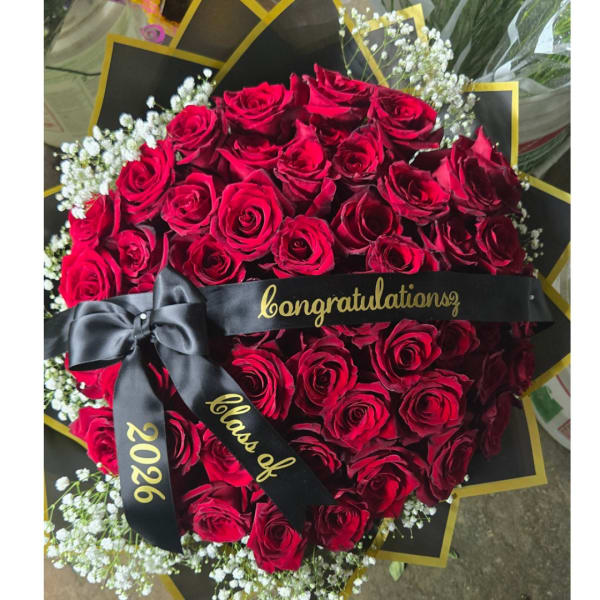 Large bouquet of red roses with white baby's breath and a black ribbon
