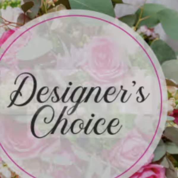 Round floral sign reading "Designer’s Choice" over pink flowers