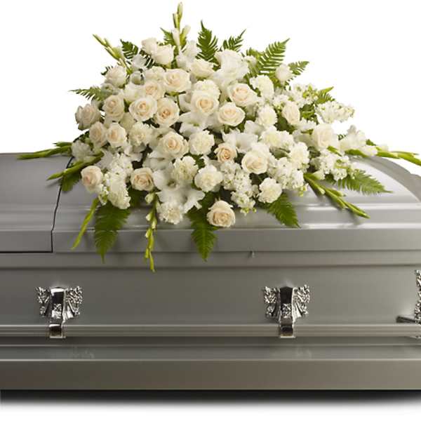 White floral casket spray on a gray casket