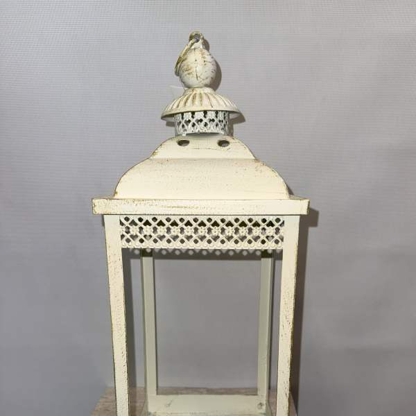 Decorative cream metal lantern with glass panels