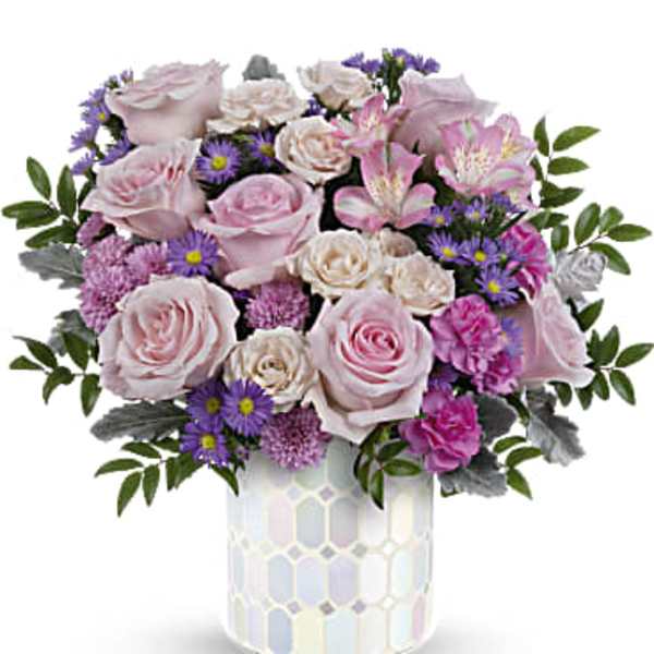 Pink roses and purple daisies in a mosaic vase