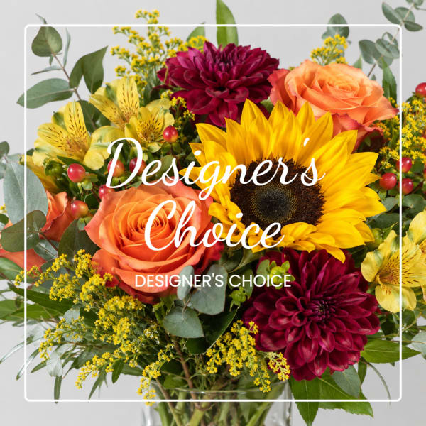Bouquet of sunflowers, orange roses, and burgundy dahlias with yellow filler