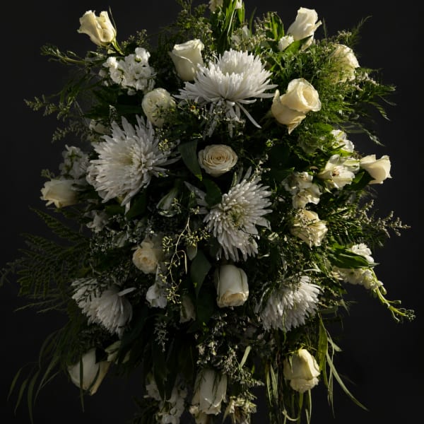 White roses and chrysanthemums arranged in a large cascading bouquet