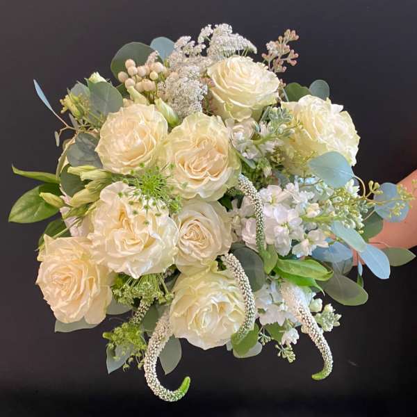 Cream rose bouquet with white filler flowers and eucalyptus