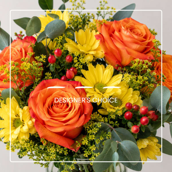 Bouquet of orange roses and yellow daisies with red berries