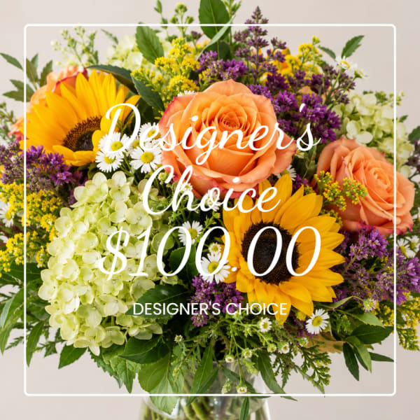 Mixed bouquet with sunflowers, peach roses, and hydrangeas in a vase