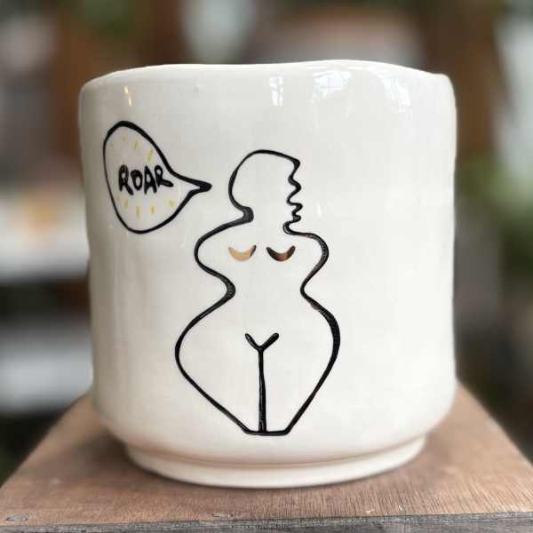 White ceramic mug with a line drawing of a nude figure and a speech bubble