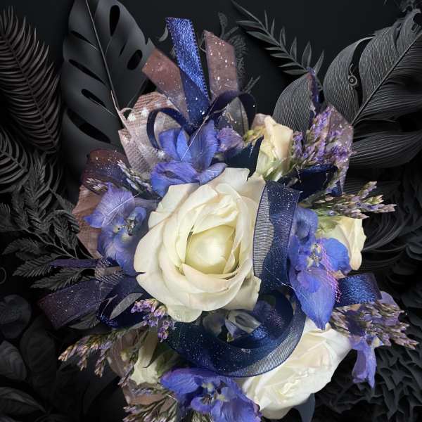 White roses with blue flowers and dark ribbon on a black background
