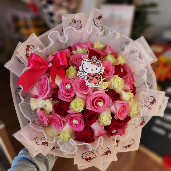 Bouquet of pink, red, and cream roses with Hello Kitty wrapping and a pink bow