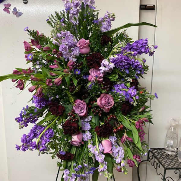 Tall purple and pink floral spray on a stand
