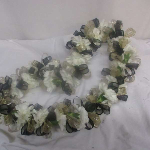 White floral lei with black and gold ribbon loops