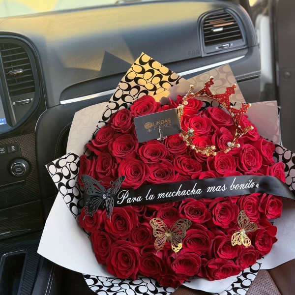 Large bouquet of red roses with butterfly decorations and a ribbon