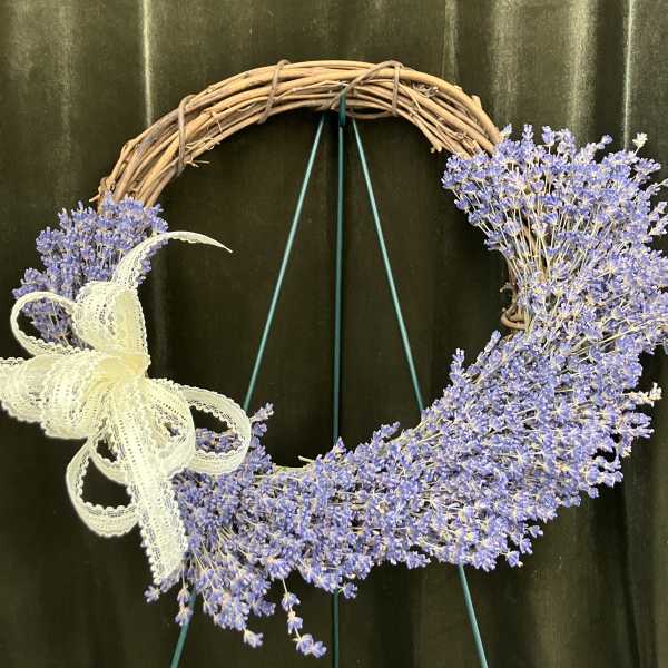 Lavender floral wreath on a grapevine ring with a lace bow