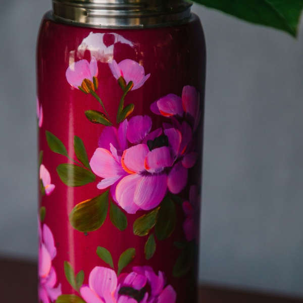 Pink floral-painted tumbler with a metal lid