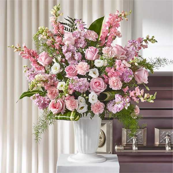 Pink and white floral arrangement in a white vase