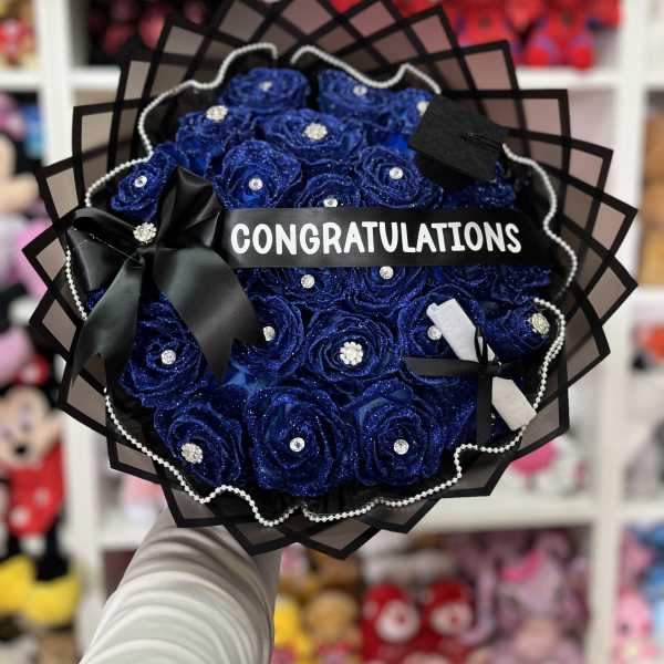 Blue rose bouquet with a congratulations ribbon and black wrapping