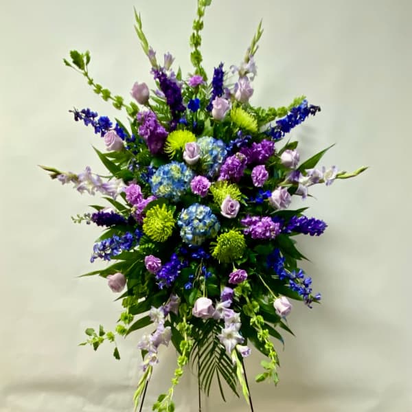 Tall standing floral spray with purple, blue, and green flowers