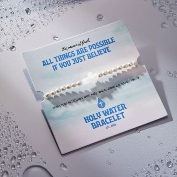 Pearl bracelet on a printed card with blue text