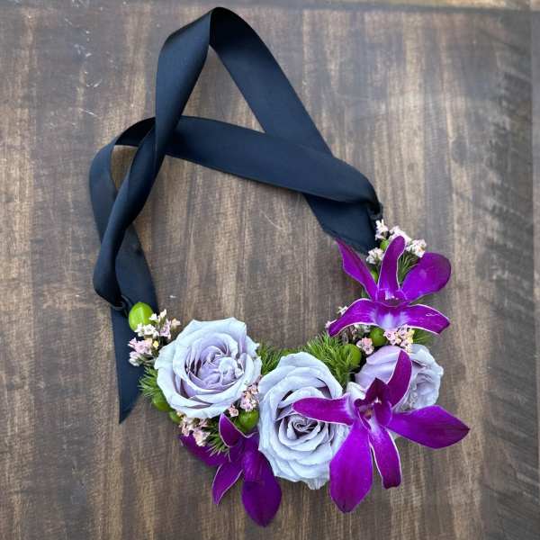 Floral necklace with lavender roses and purple orchids on a dark ribbon