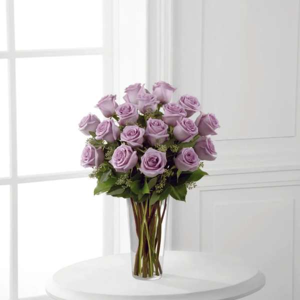 Lavender rose bouquet in a clear glass vase