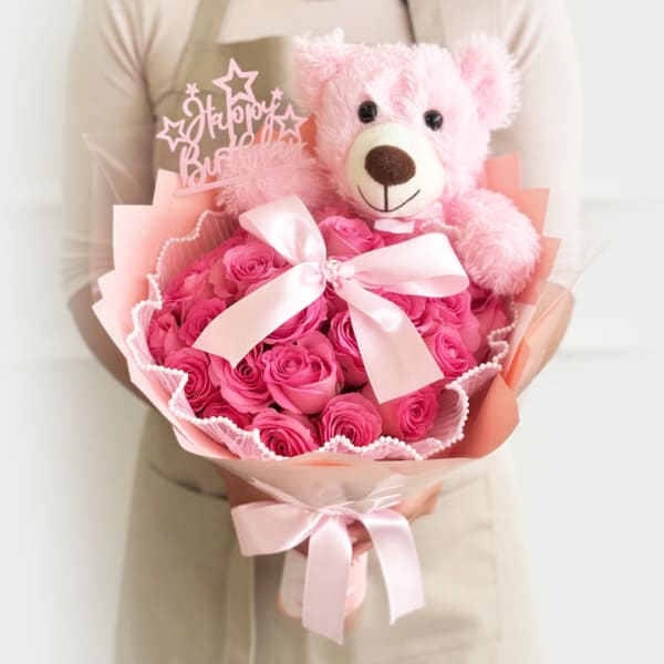 Pink rose bouquet with a teddy bear and ribbon bow