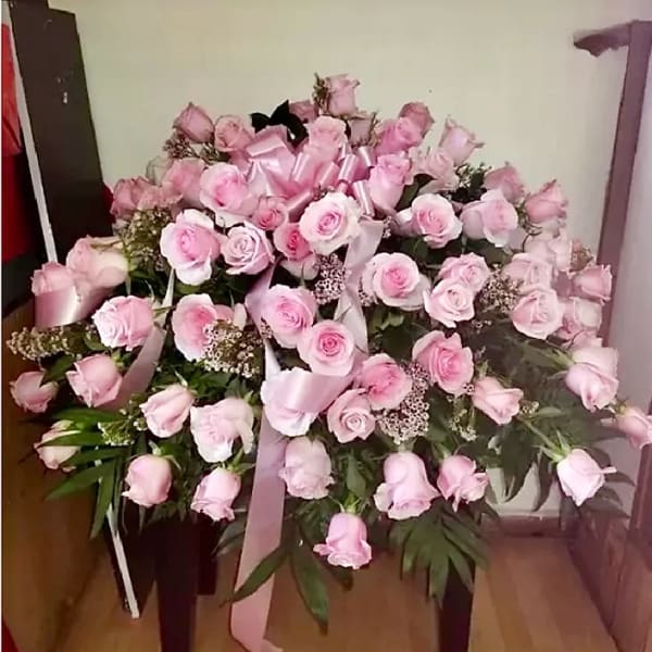 Large bouquet of pink roses with satin ribbon on a stand