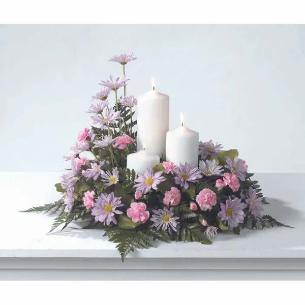 Lavender and pink floral centerpiece with three white candles