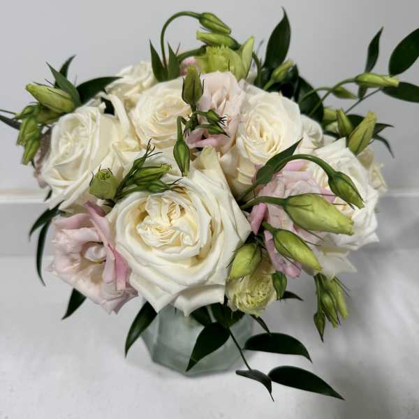 White and blush rose bouquet in a glass vase